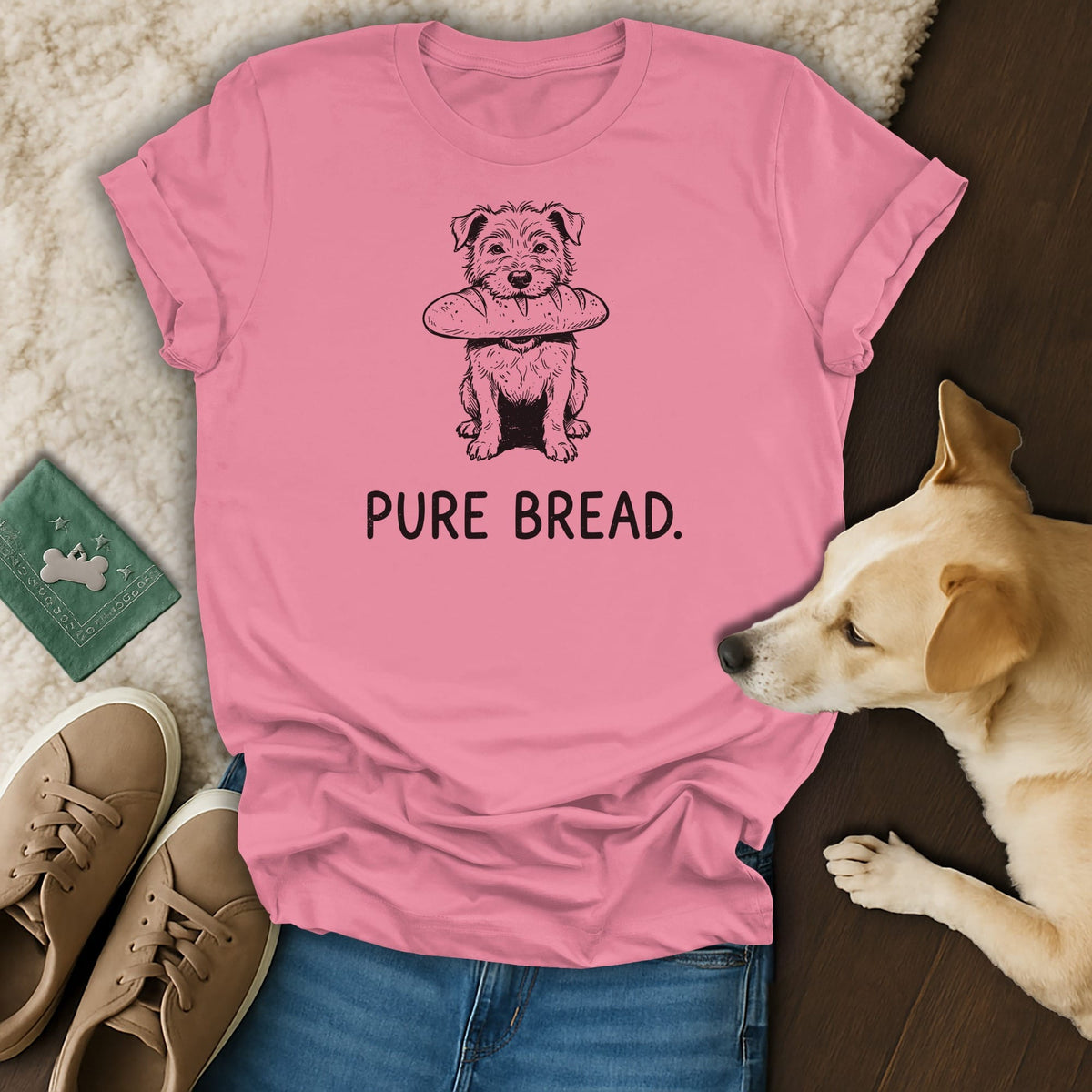 Pink t-shirt with a sketch of a dog holding a baguette and text "PURE BREAD."