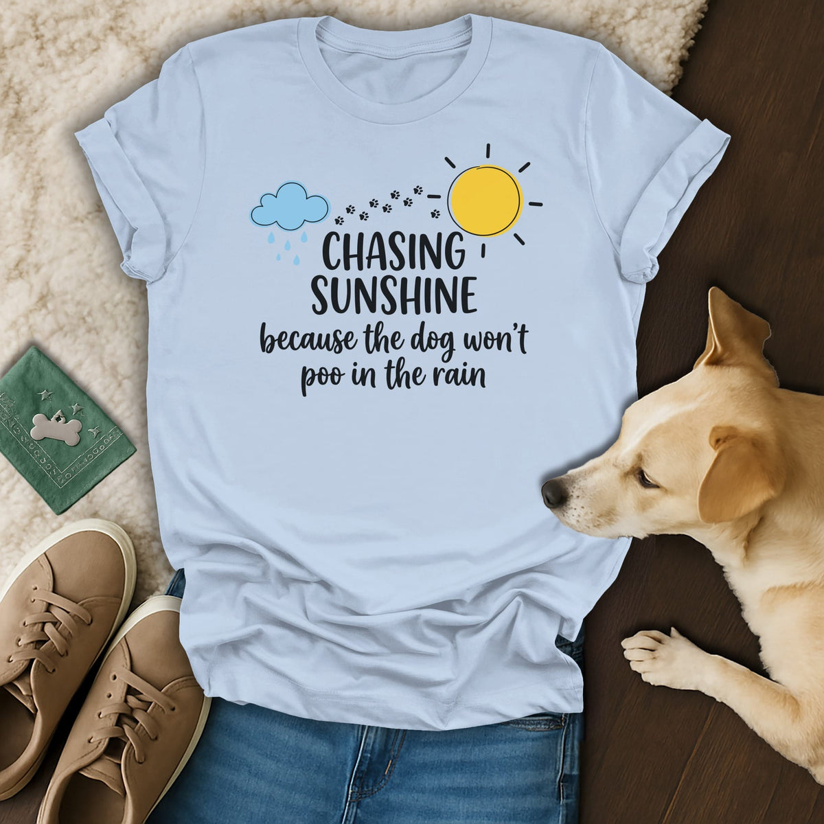 Light blue t-shirt with "Chasing Sunshine because the dog won't poo in the rain" text.