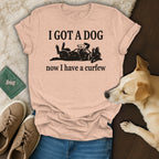 Light pink t-shirt with black text "I GOT A DOG now I have a curfew" and dog graphic.
