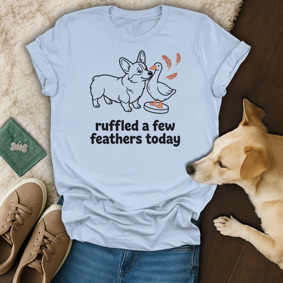 Light blue t-shirt with a cartoon corgi and goose graphic and "ruffled a few feathers today" text.