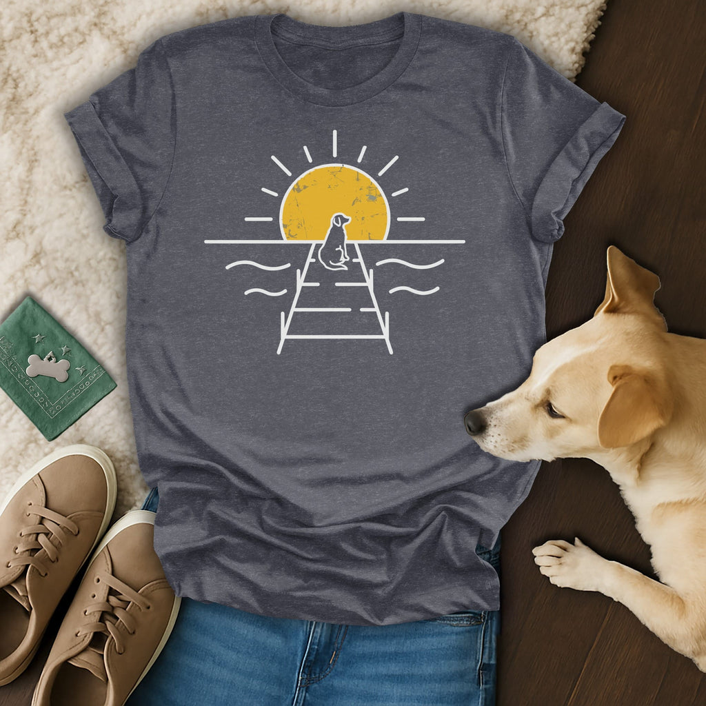 Dark t-shirt with a white graphic of a dog on a pier at sunset.
