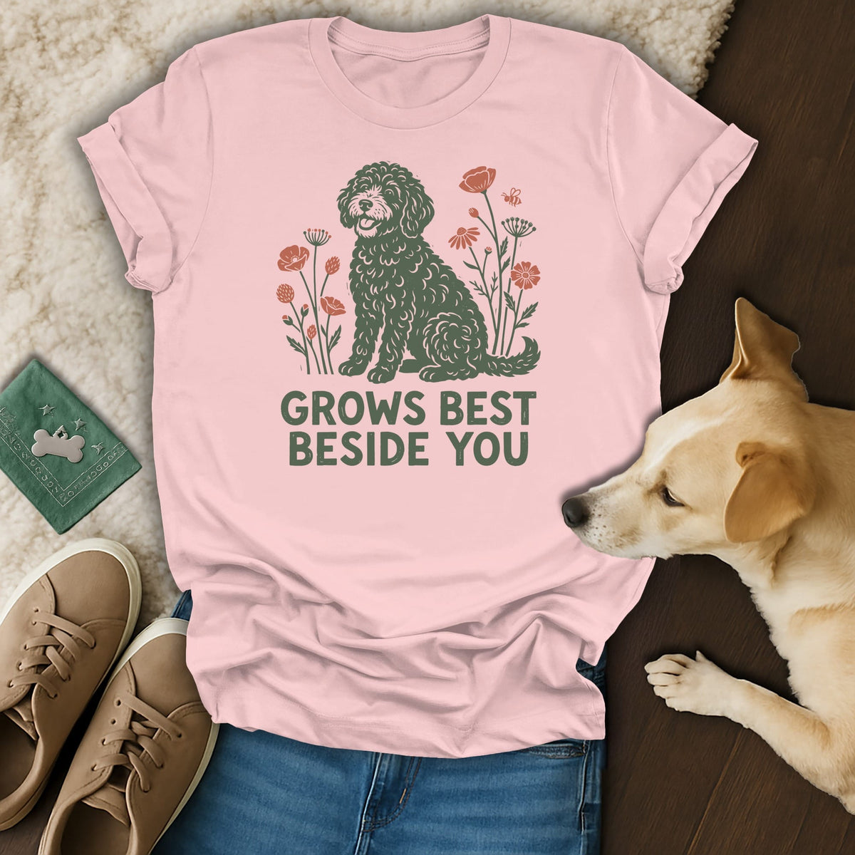 A light pink t-shirt with a graphic of a dog and flowers reads GROWS BEST BESIDE YOU.