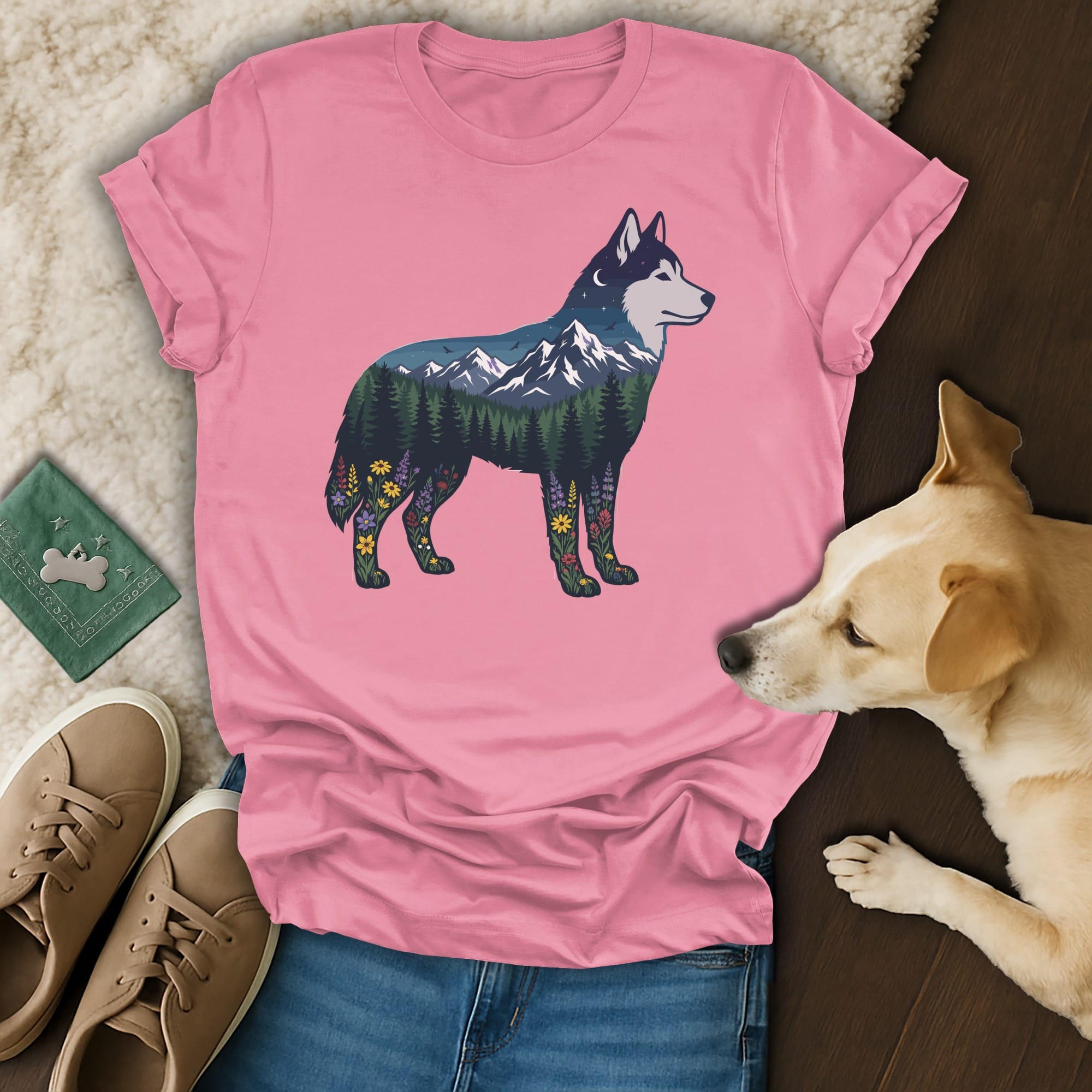 Pink t-shirt with a wolf silhouette filled with a mountain forest landscape.