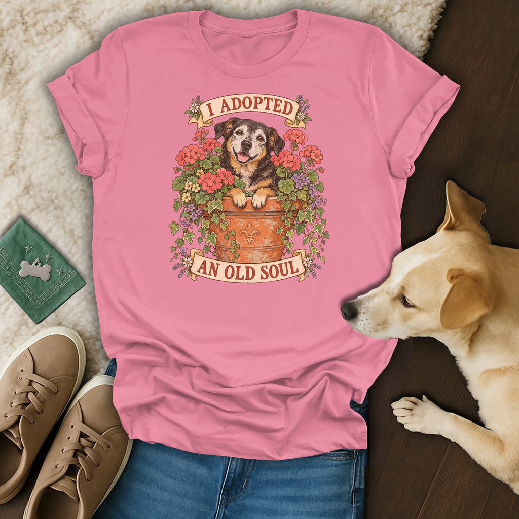 A pink t-shirt featuring a graphic of an older dog in a flower pot with the text I Adopted An Old Soul.