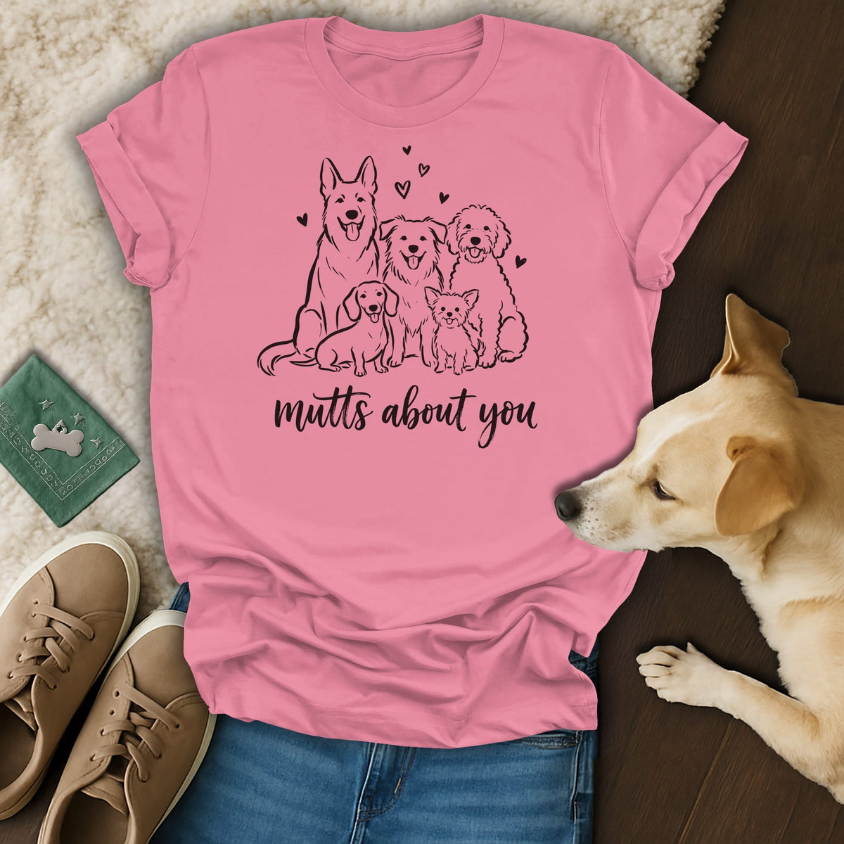Pink t-shirt with black line drawing of five dogs and "mutts about you" text.
