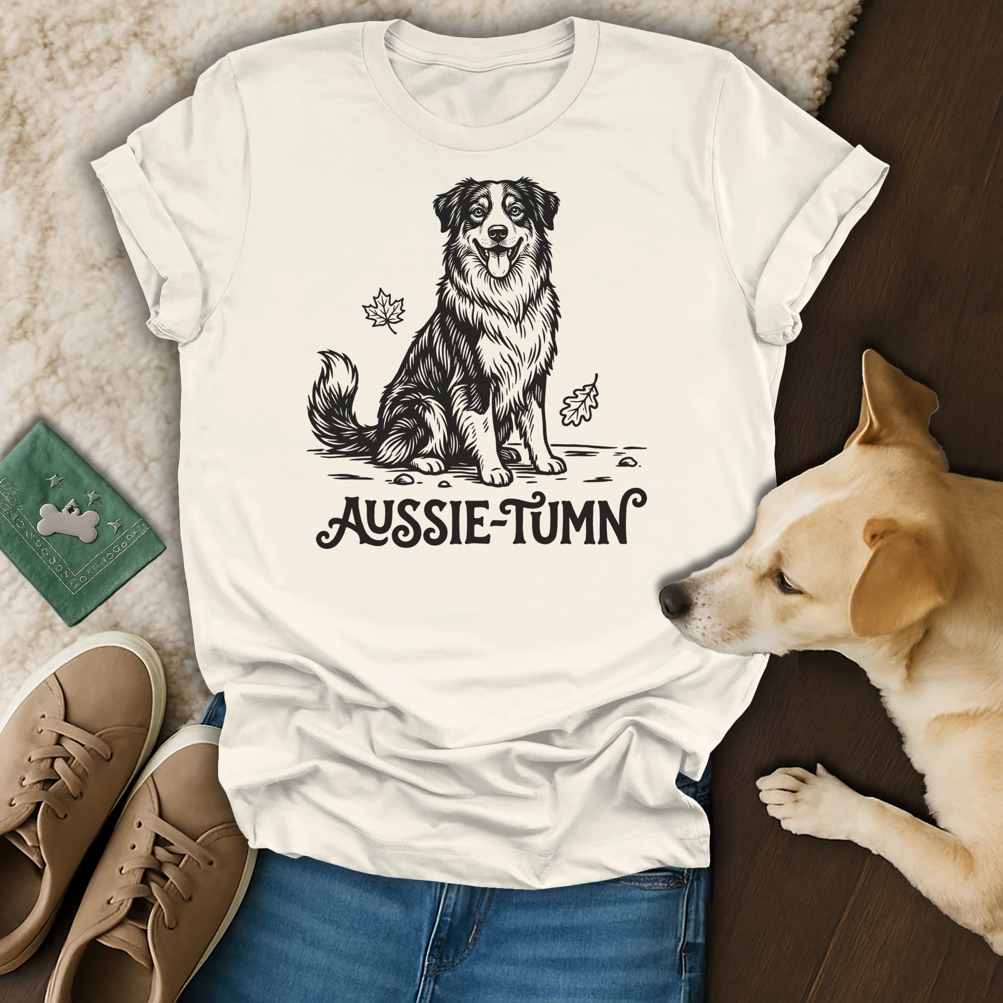Cream t-shirt with black line art of a smiling Australian Shepherd and "Aussie-Tumn" text.