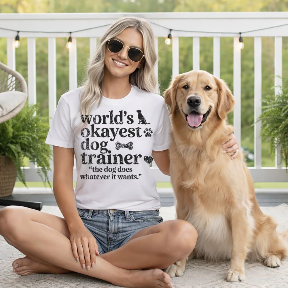 Woman wearing a t-shirt with dog graphic and text, posing with golden retriever.