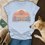 Light blue t-shirt with "inhale, exhale, wag" and meditating dog, sunset, and yoga design.