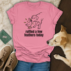 Pink t-shirt with a line drawing of a dog and duck and text "ruffled a few feathers today".