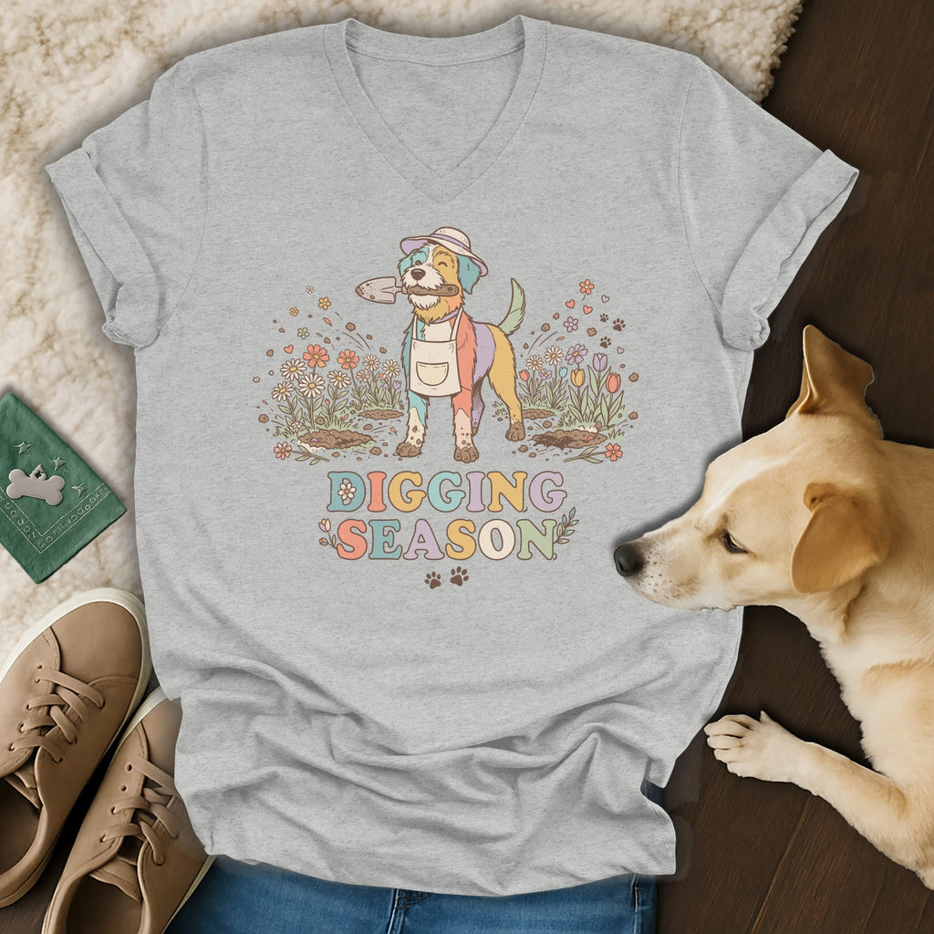 Gray t-shirt with a dog wearing a hat and apron holding a shovel, with flowers and text.