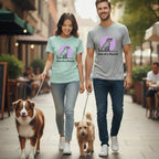Couple walking two dogs on leashes, both wearing matching "One of a Hound" t-shirts.