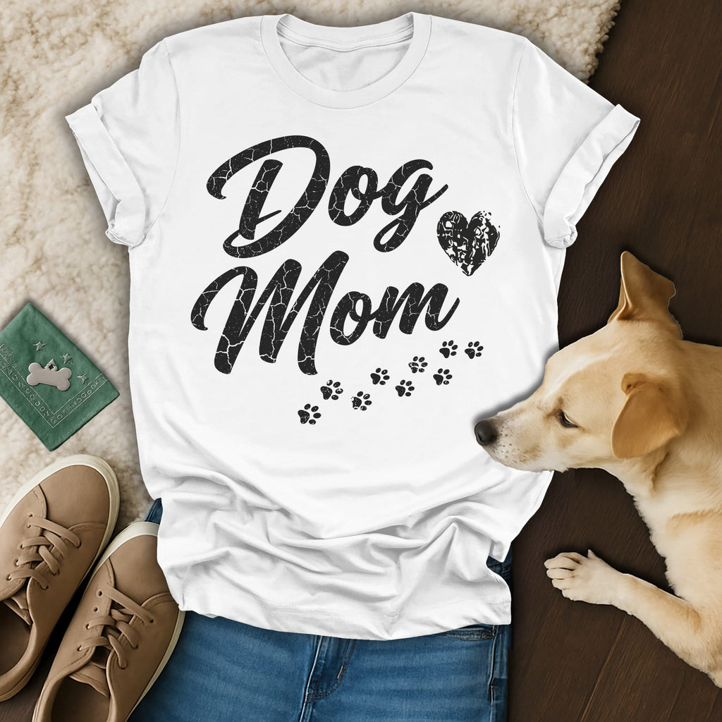 White t-shirt with "Dog Mom" text and paw prints, a dog, and shoes.