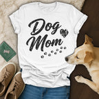 White t-shirt with "Dog Mom" text and paw prints, a dog, and shoes.