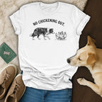 White t-shirt with black graphic of border collie approaching chickens, text "NO CHICKENING OUT."