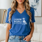 Blue V-neck t-shirt with white graphic: "I KNOW PEOPLE mostly by their dogs" and a dog illustration.