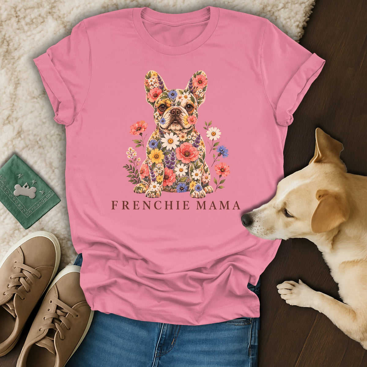 A pink t-shirt featuring a French bulldog graphic made of flowers and the text Frenchie Mama.
