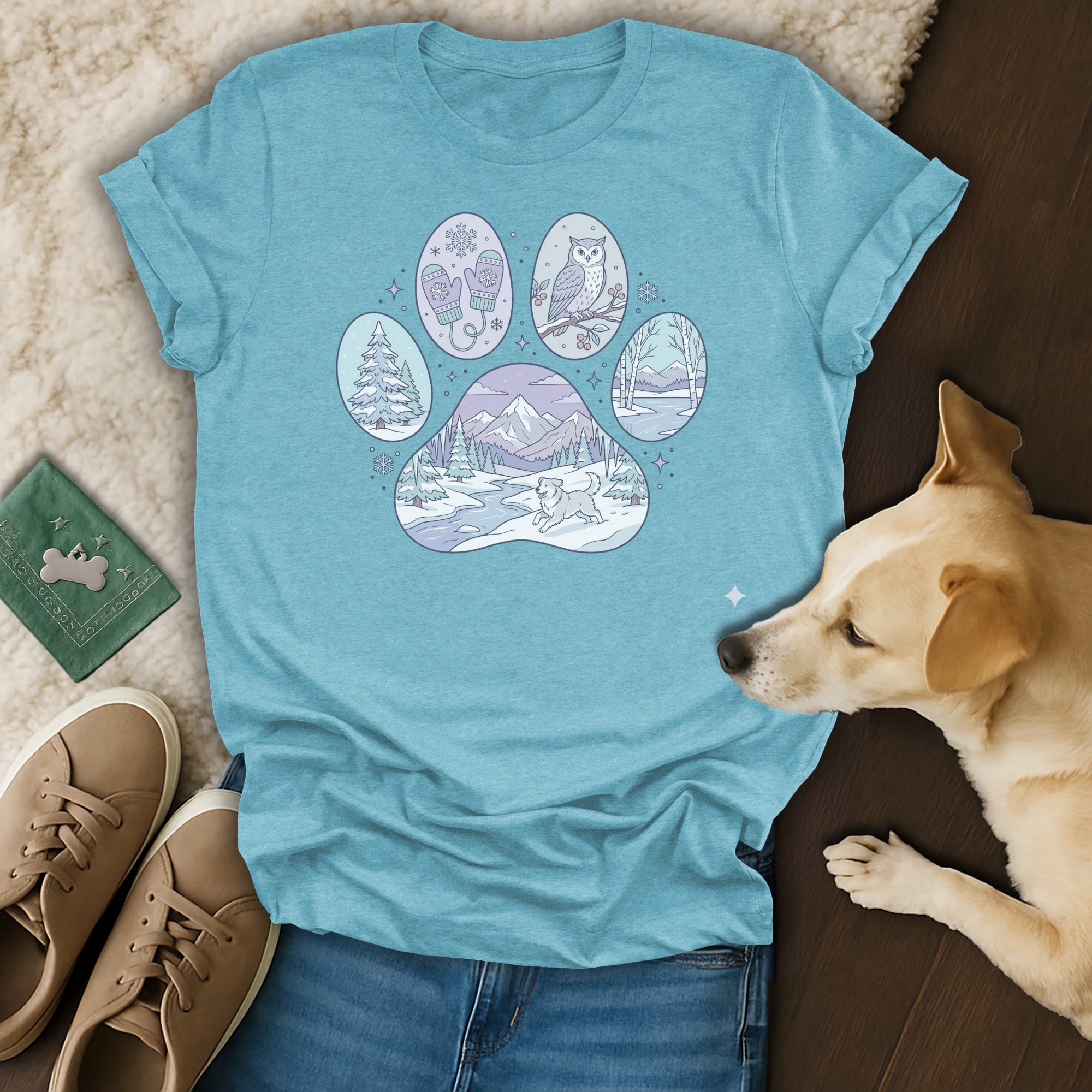 T-shirt with a paw print design featuring winter scenes and animals.