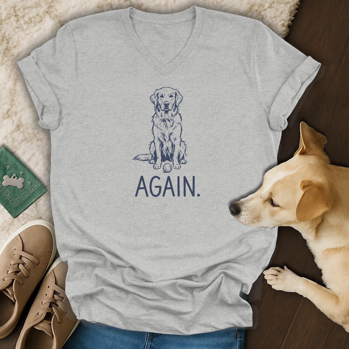 Light grey t-shirt with a navy sketch of a dog and the word "AGAIN."