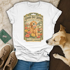 A white t-shirt featuring a vintage seed packet graphic with a golden retriever holding a zinnia packet.