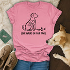 Pink t-shirt with a dog outline, hearts, and "Love Walks on Four Paws" text.