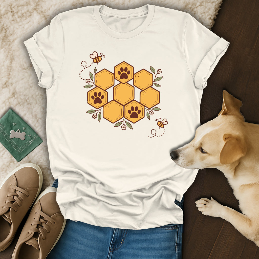 White t-shirt with a honeycomb paw print design, bees, flowers, blue jeans, shoes, and a dog.