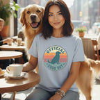 Woman with golden retriever wearing "Official Good Boy" t-shirt.