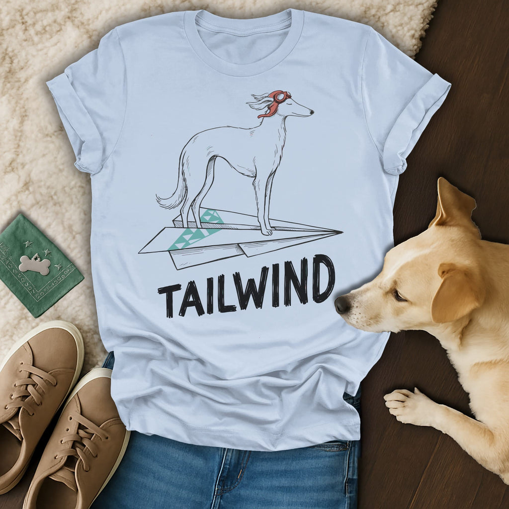 Light blue t-shirt with a dog on a paper airplane graphic and "TAILWIND" text.