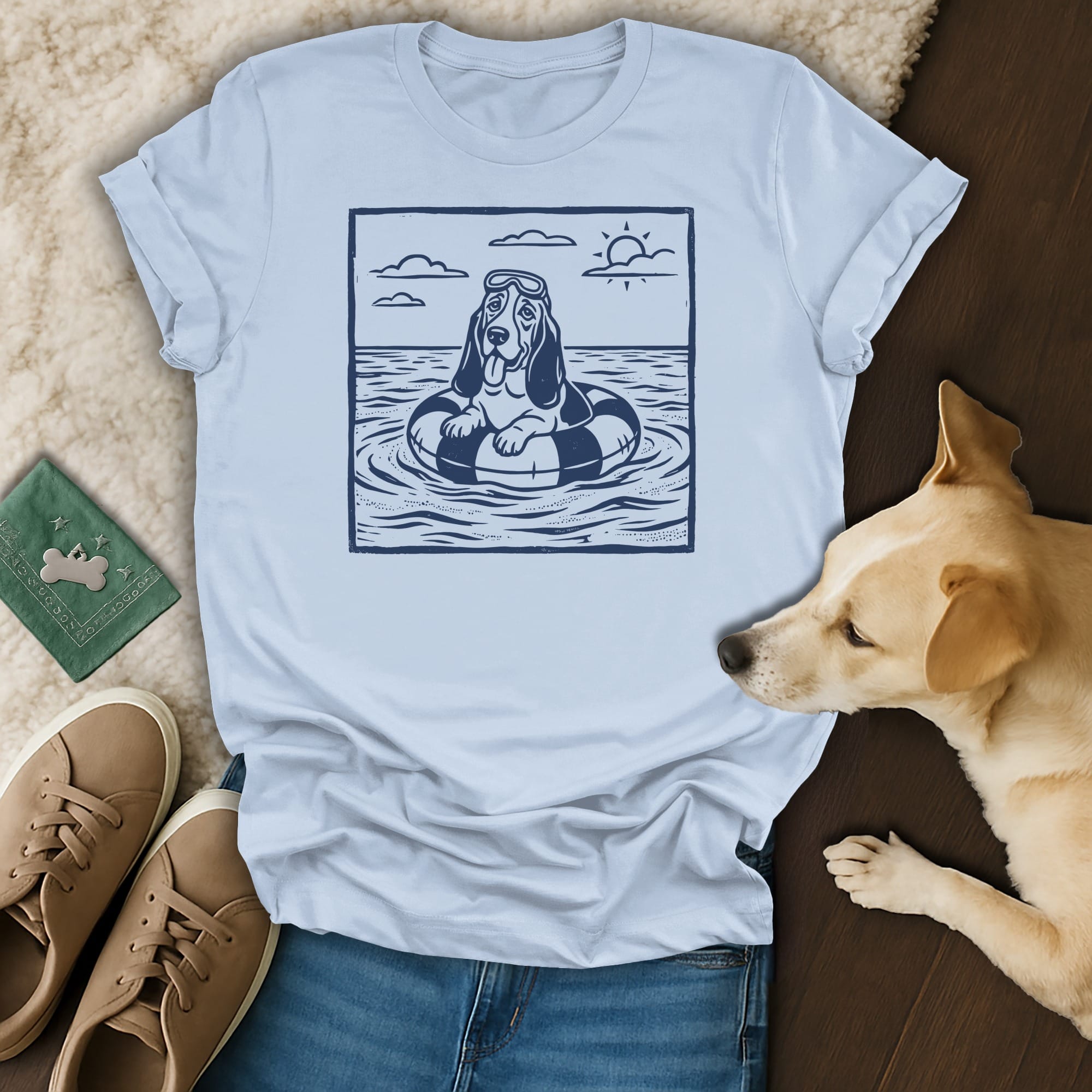 T-shirt featuring a dog in a life preserver, wearing goggles, on the water.
