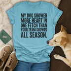 Blue t-shirt with "My dog showed more heart in one fetch than your team showed all season" text.