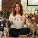 Woman wearing short-sleeve shirt with cartoon dogs roller skating graphic, petting two dogs.