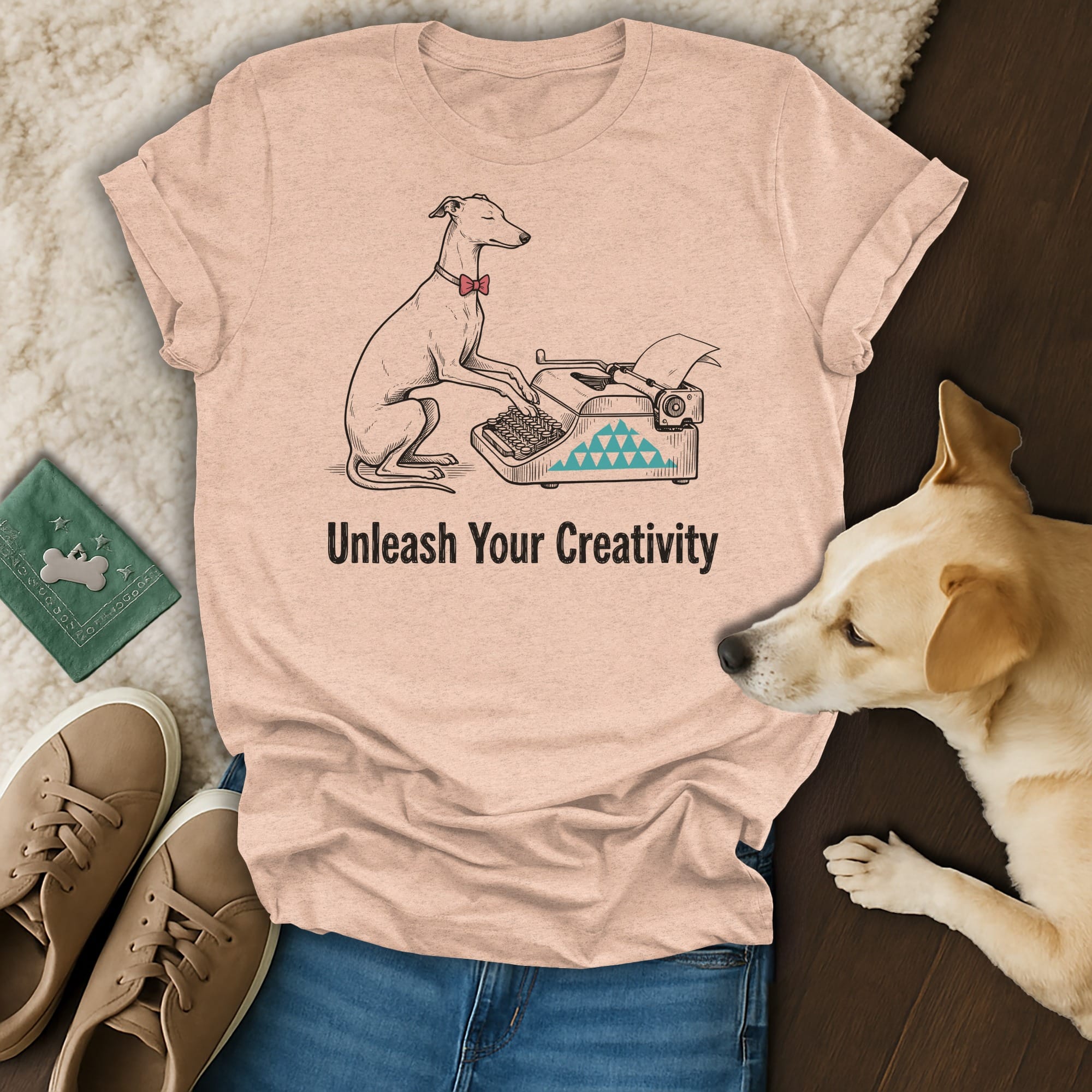 T-shirt with a dog typing on a vintage typewriter, text reads "Unleash Your Creativity."