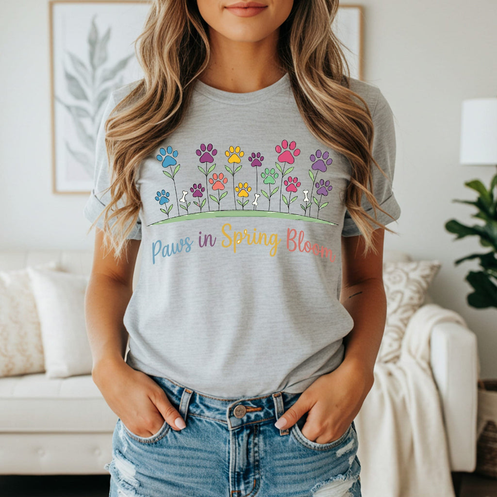 Grey t-shirt with colorful paw print flowers and "Paws in Spring Bloom" text.