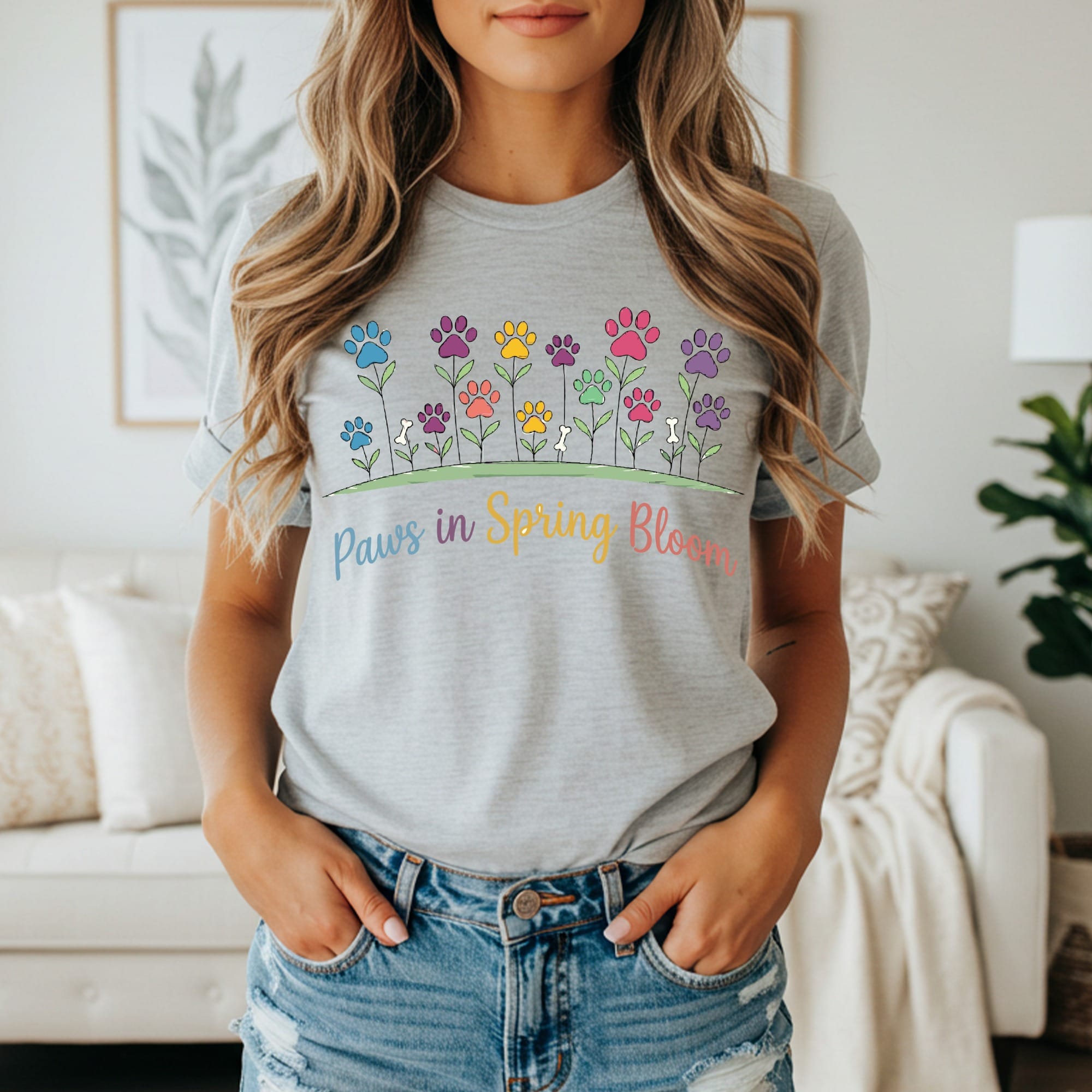 Grey t-shirt with colorful paw print flowers and "Paws in Spring Bloom" text.