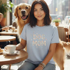 Woman with golden retriever wearing light blue t-shirt with "DOG MOM" text.