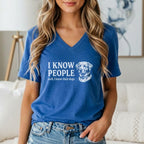 Blue v-neck t-shirt with white text "I KNOW PEOPLE well, I know their dogs" and dog graphic.