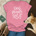 Pink t-shirt with white text "Dog people Get it" and paw prints.