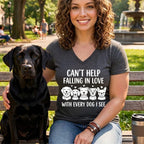 Woman with black lab sits on bench with shirt reading "Can't Help Falling in Love With Every Dog I See."