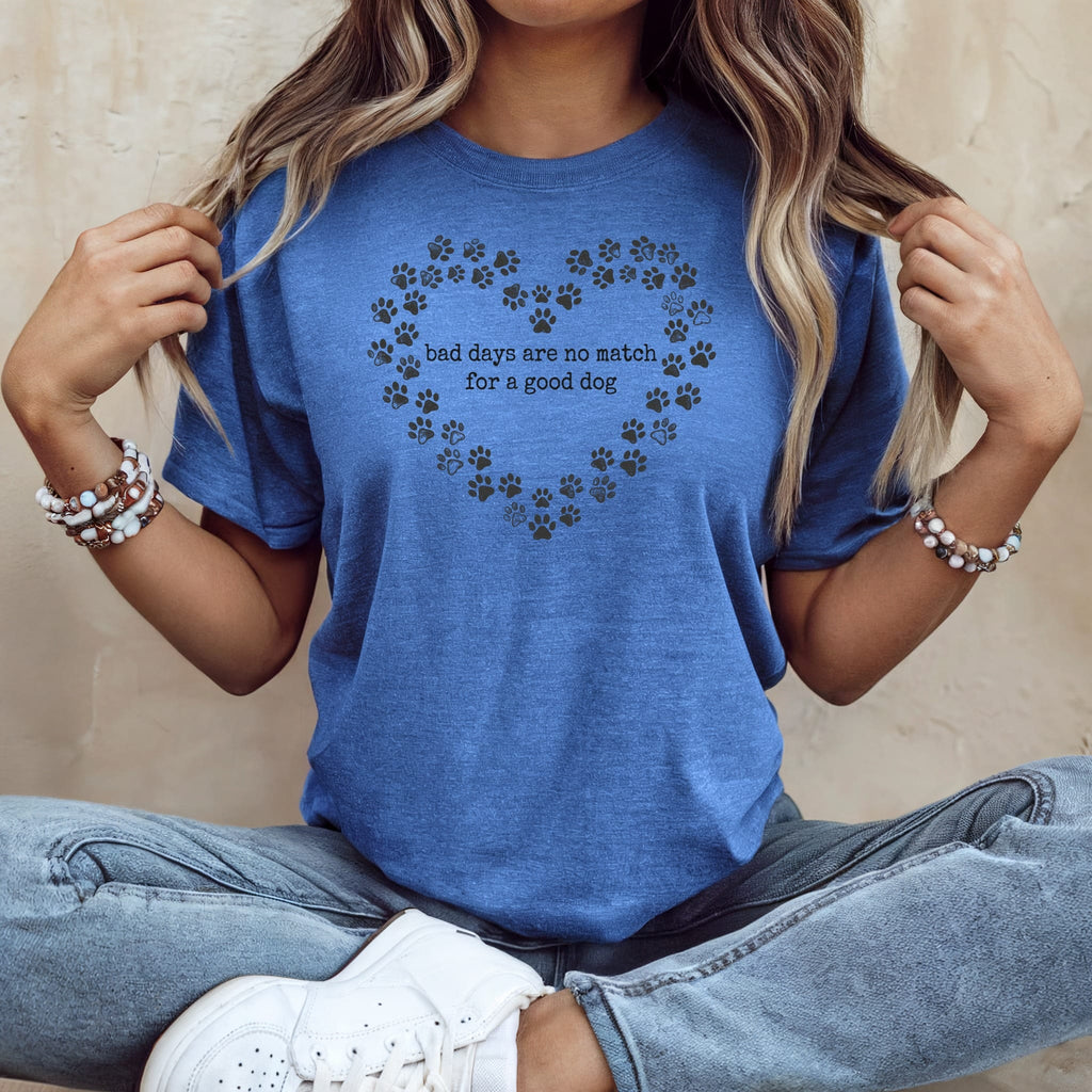 Blue t-shirt with paw print heart and text: "bad days are no match for a good dog."