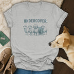 Grey t-shirt with "UNDERCOVER." and a dog disguised as a sheep.