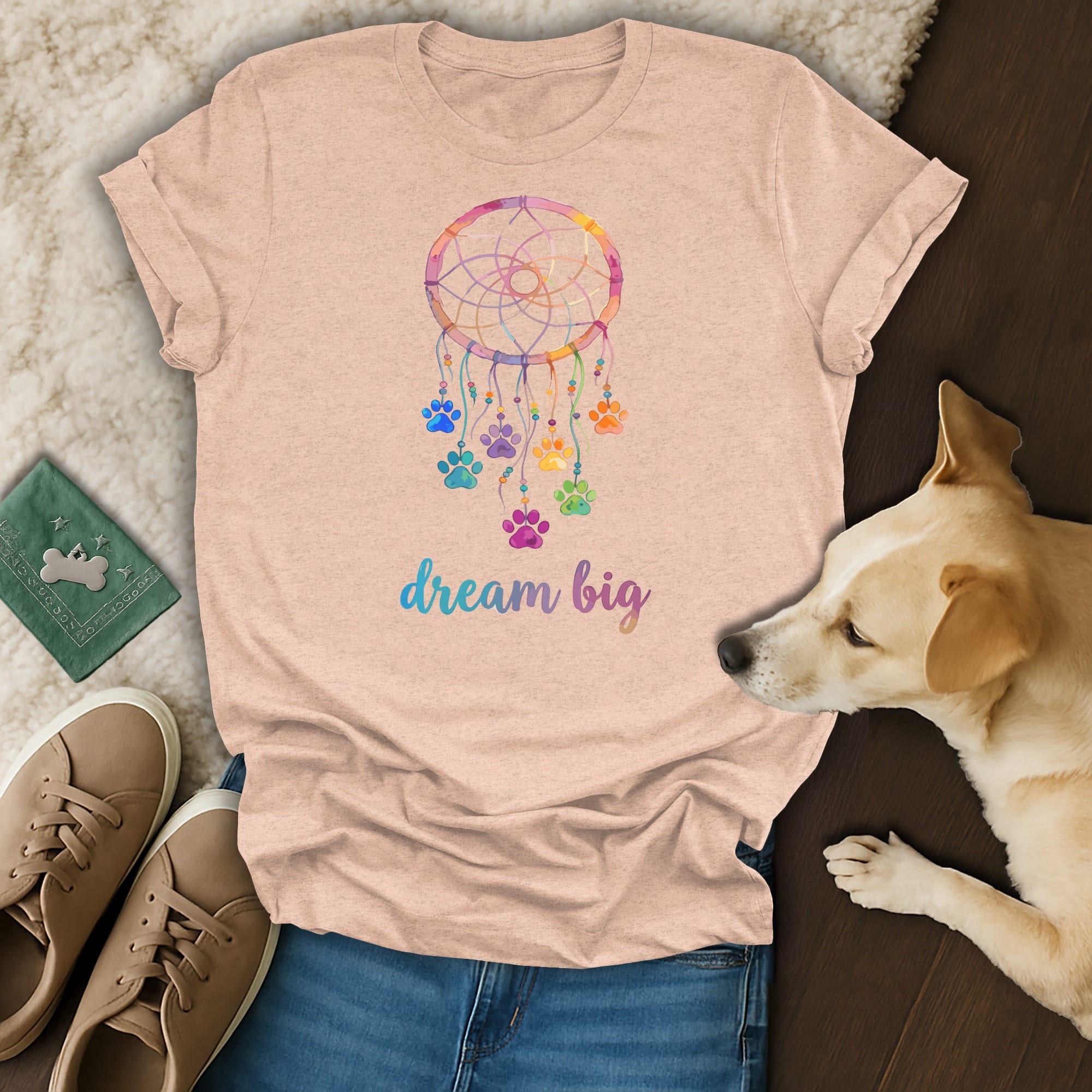 Peach t-shirt with a colorful dreamcatcher and paw prints, saying "dream big".