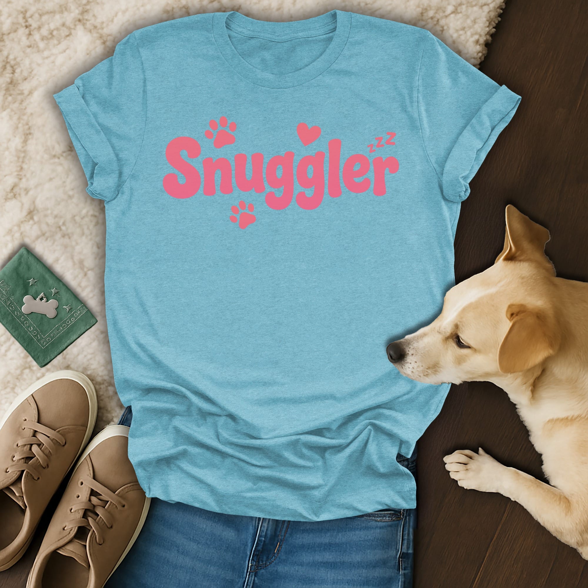 Light blue t-shirt with "Snuggler" in pink lettering and paw prints.