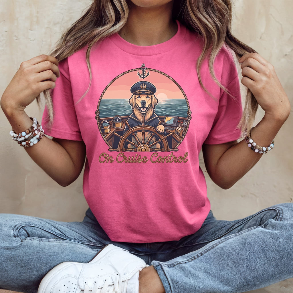 Pink t-shirt with cartoon dog wearing captain's hat at ship's wheel.