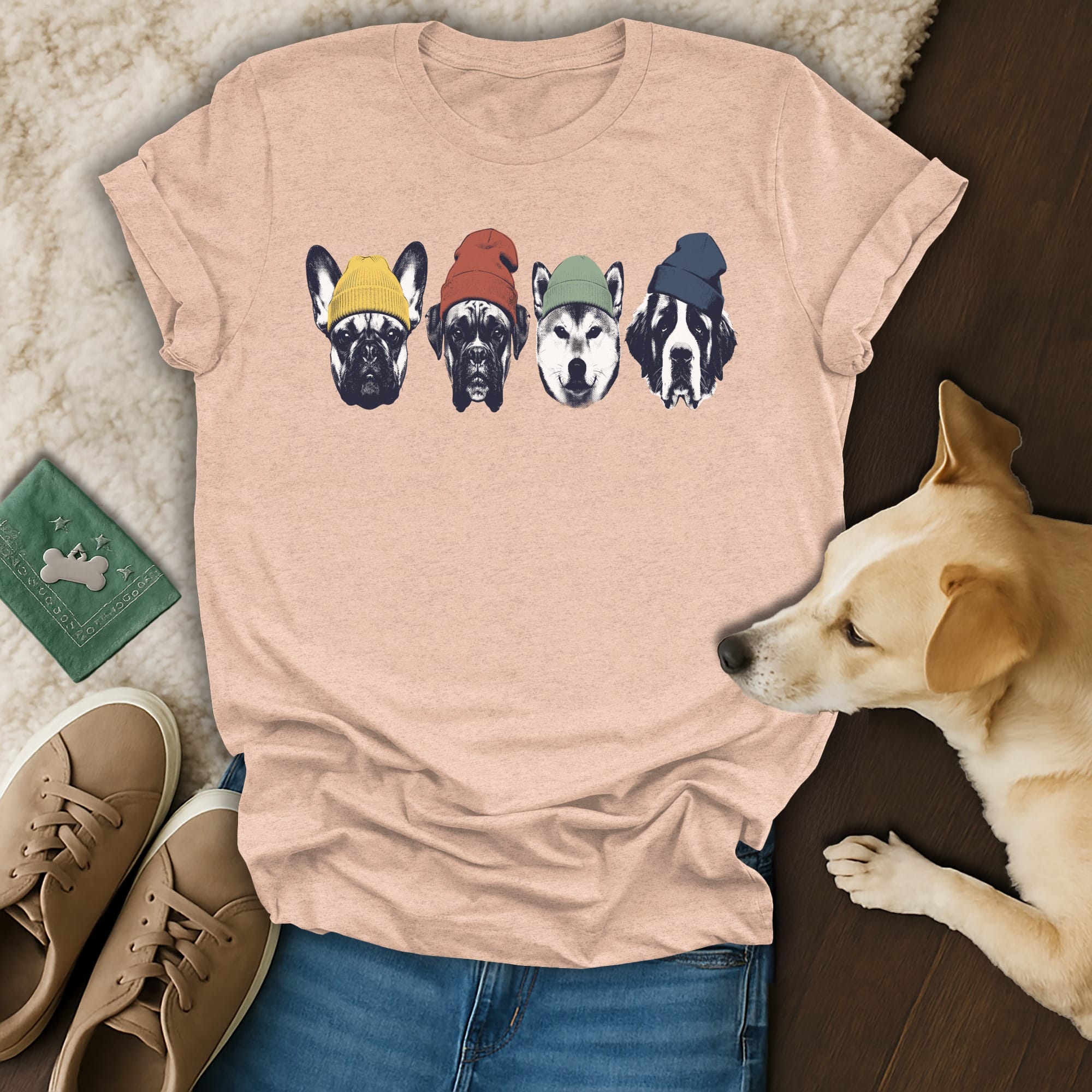 Four dog heads wearing colorful beanies on a pink t-shirt.