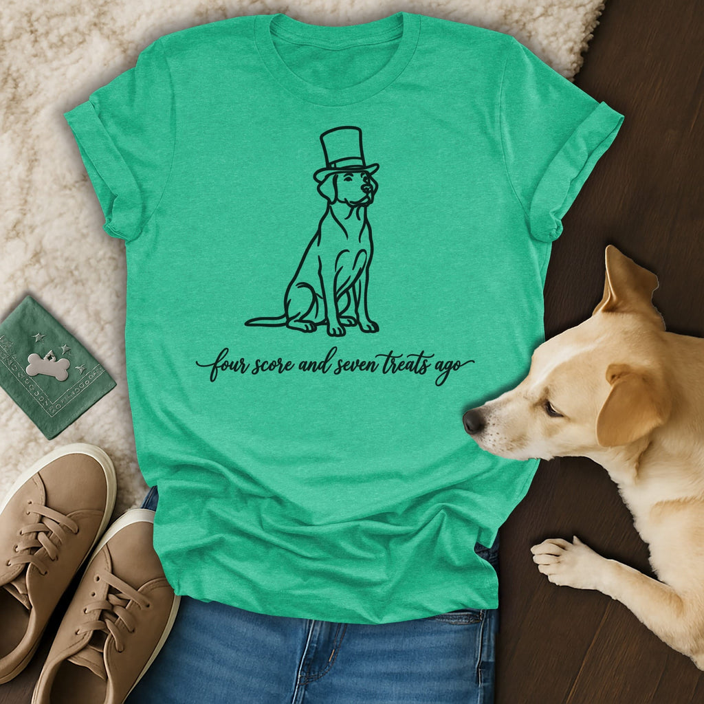 Dog wearing top hat with "four score and seven treats ago" text on a t-shirt.