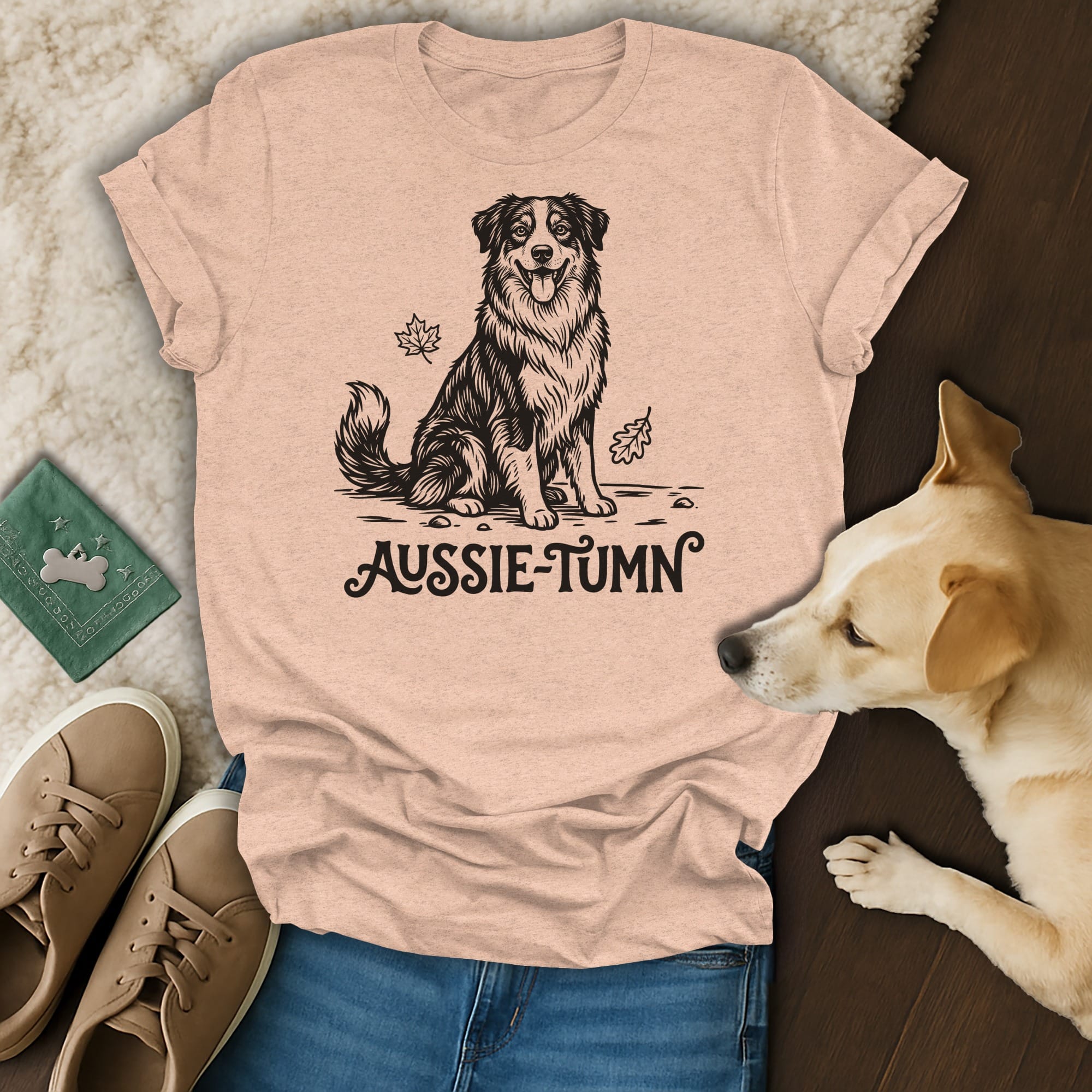 Peach t-shirt with a black ink drawing of an Australian Shepherd and the text "Aussie-Tumn".