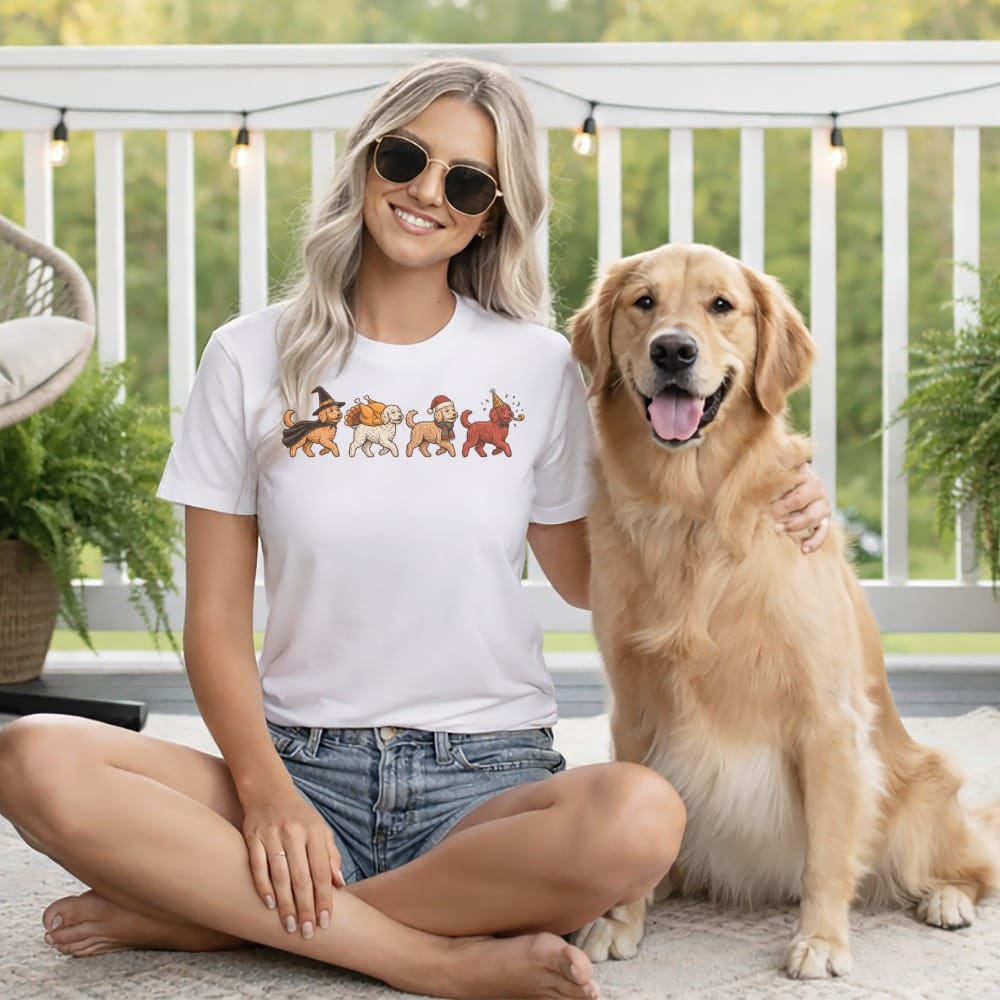 White t-shirt with cartoon dogs dressed for holidays on the chest, next to a golden retriever.