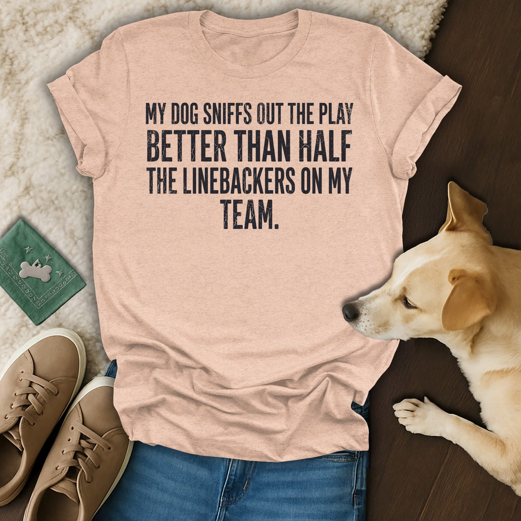 Peach t-shirt with "My dog sniffs out the play better than half the linebackers on my team." text.