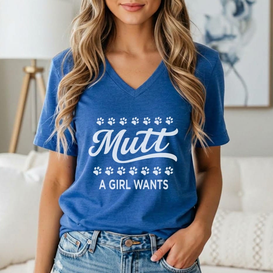 Blue v-neck t-shirt with white text "Mutt A GIRL WANTS" and paw prints.