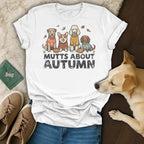White t-shirt with "Mutts About Autumn" text and four dogs in sweaters.