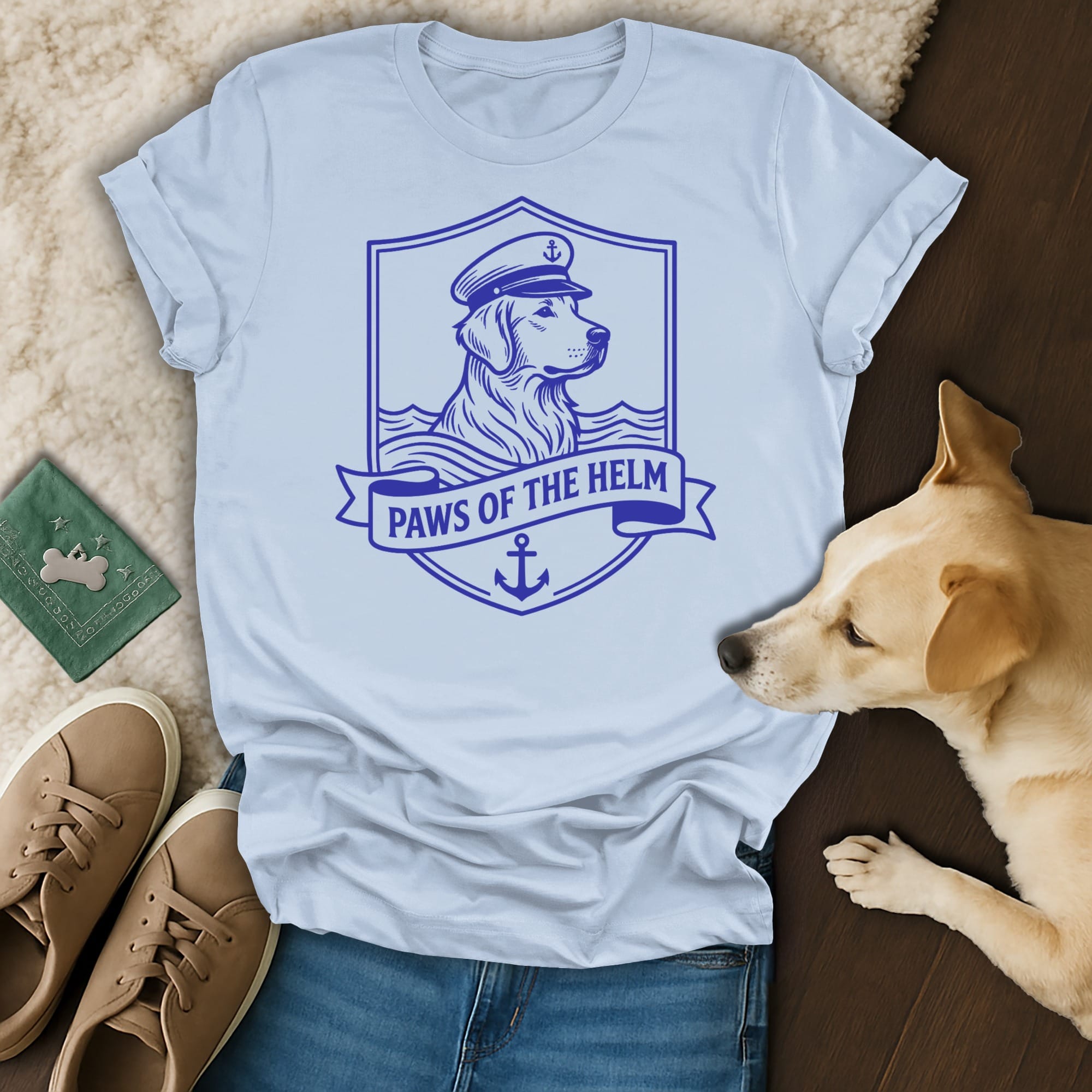 Light blue t-shirt with a golden retriever wearing a captain's hat and the text "Paws of the Helm".